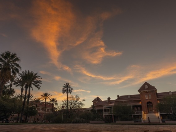 old main with whispy clouds above at sunset